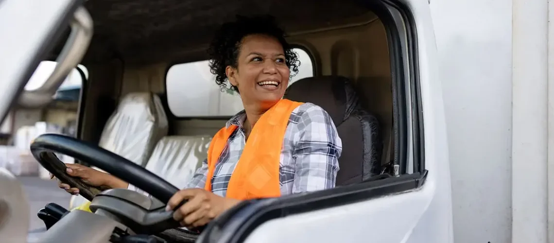female-truck-driver-smiling-cab-1200x628